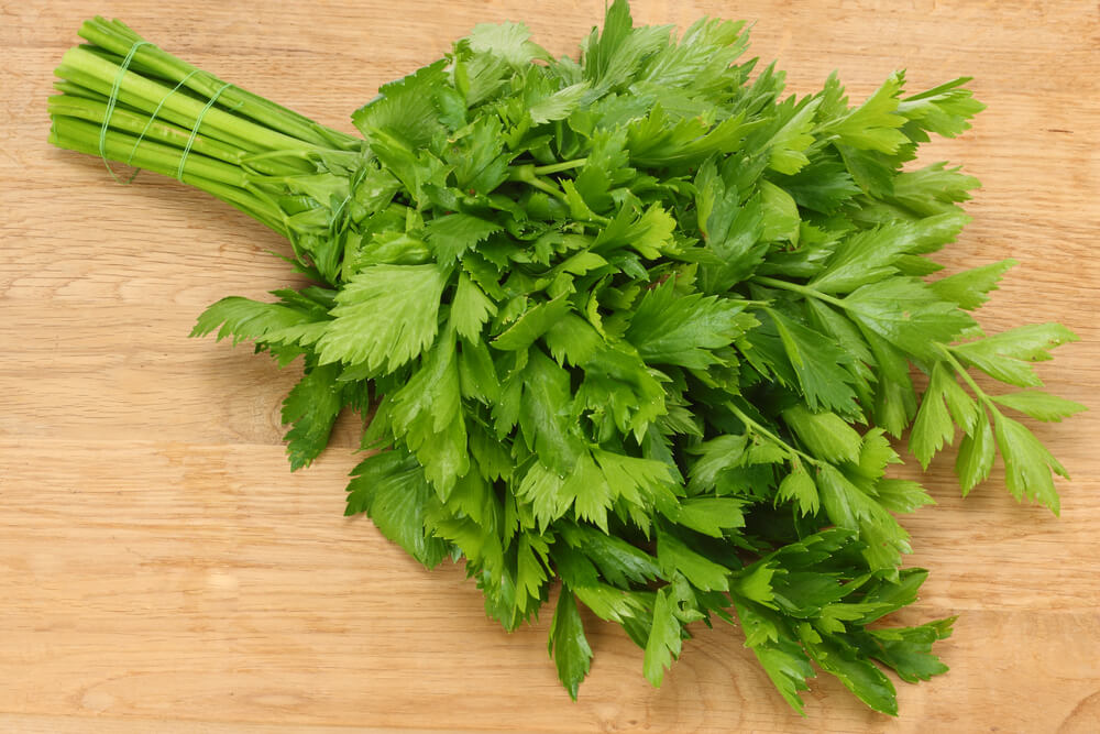 a bundle of fresh parsley on a wooden cutting board